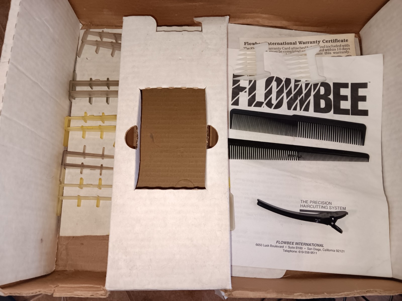 Flowbee Haircutting System tested in box with attachments