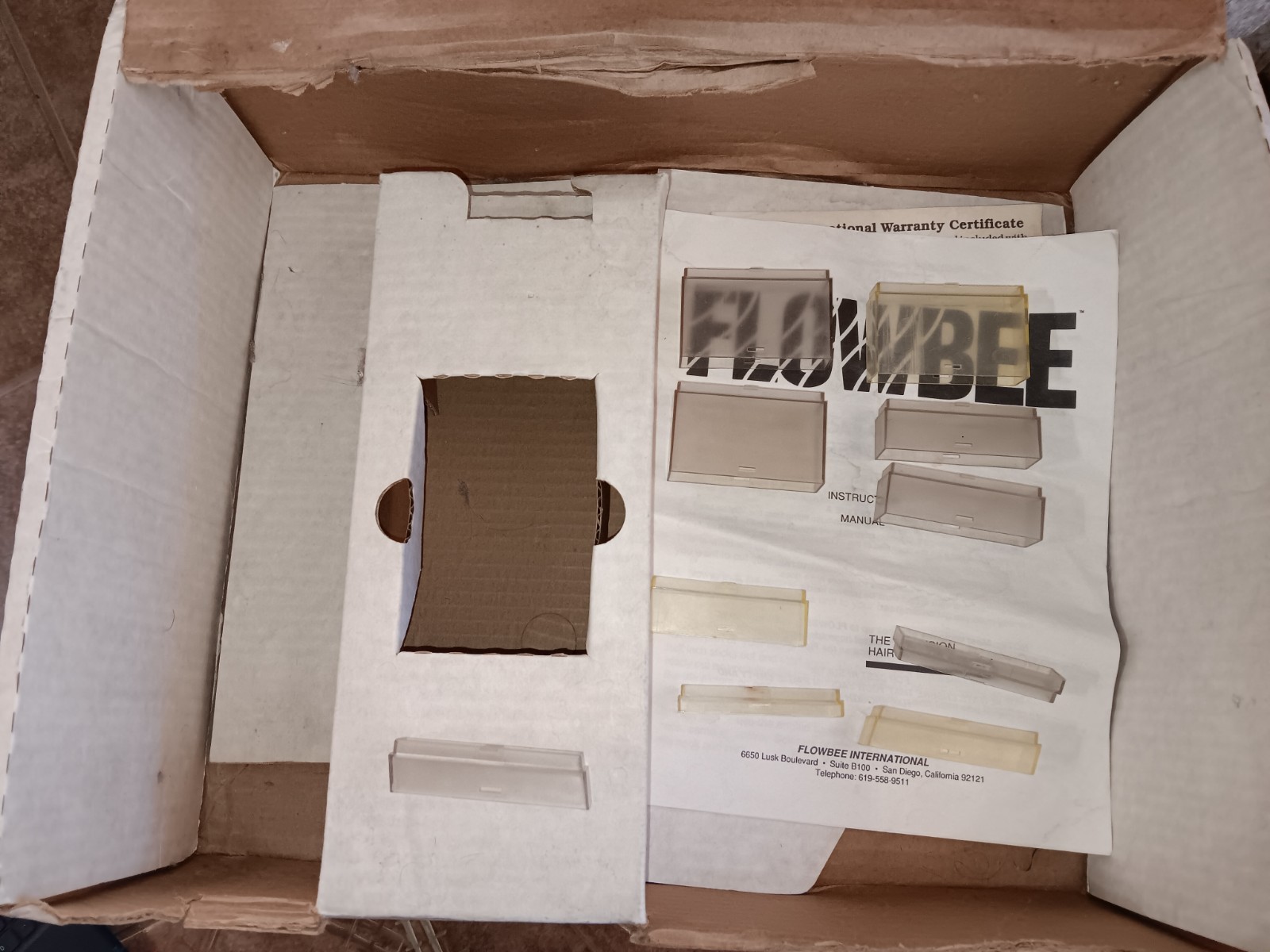 Flowbee Haircutting System tested in box with attachments
